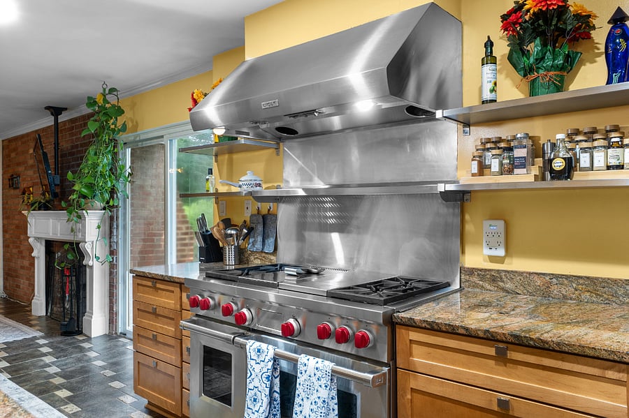 Home chefs dream kitchen with Wolf range, double ovens, and endless prep space.
