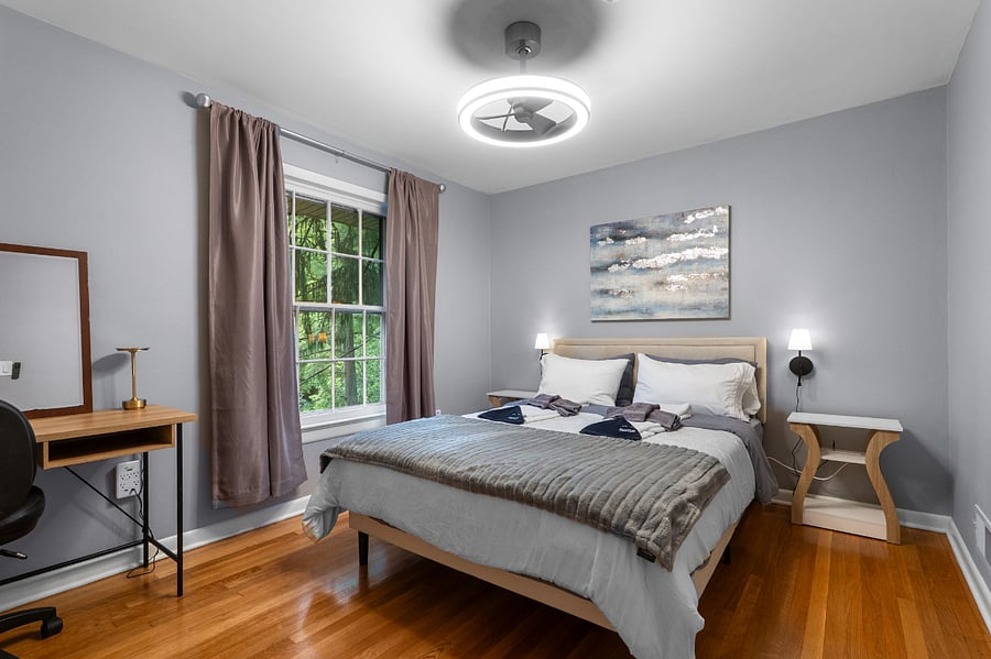 Spacious secondary bedroom with oversized windows and abundant natural light.