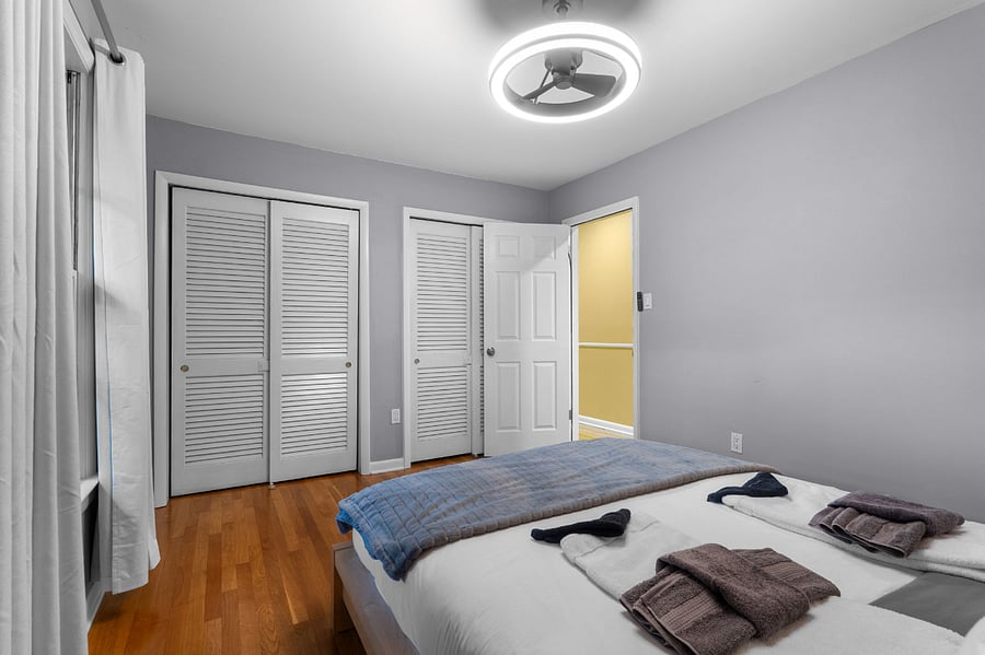 Large third bedroom with expansive windows, perfect for guests, office, or play.