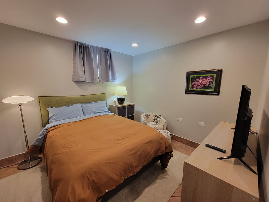 Queen-sized sofa, storage and TV.