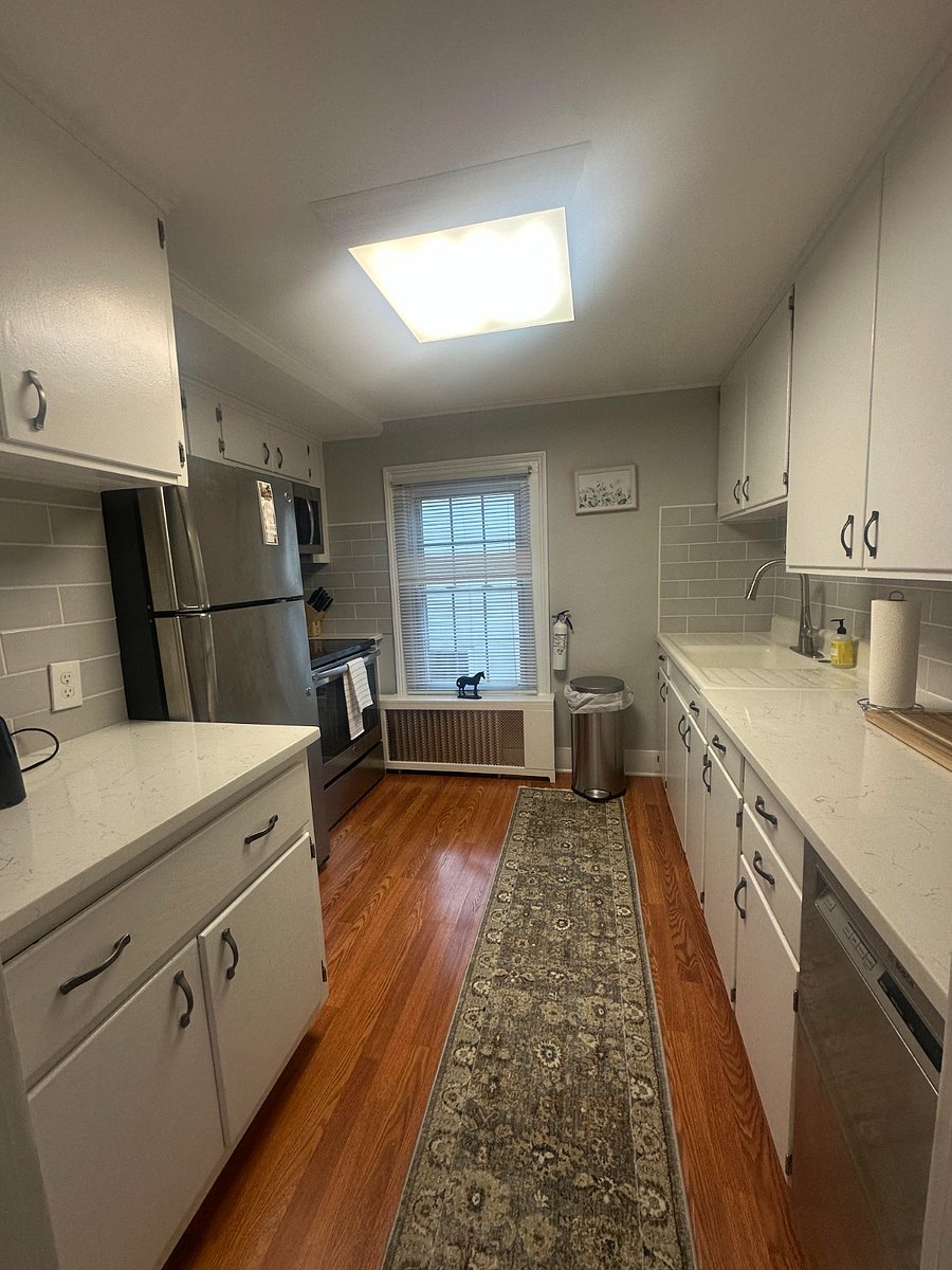 updated kitchen with quartz counter tops, stainless steel fridge, oven, dishwasher, microwave. fully stocked with everything you need to cook