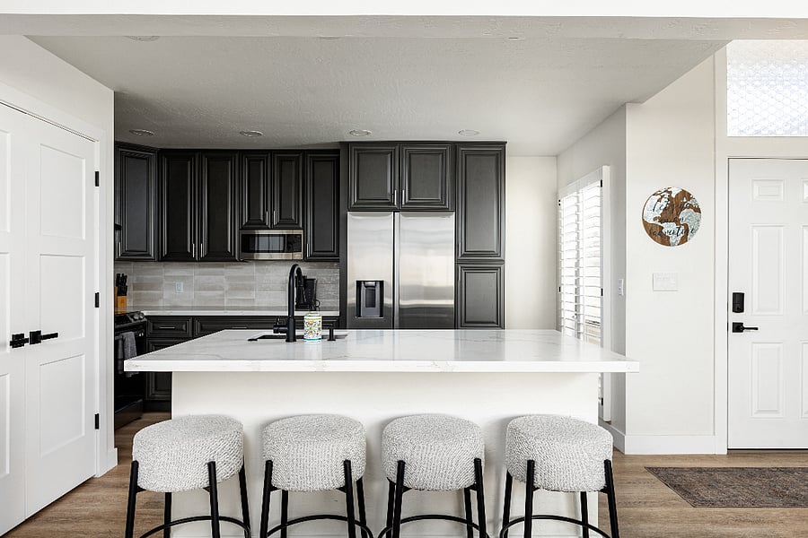 Kitchen with full size Refrigerator and beautiful Stone Countertops.