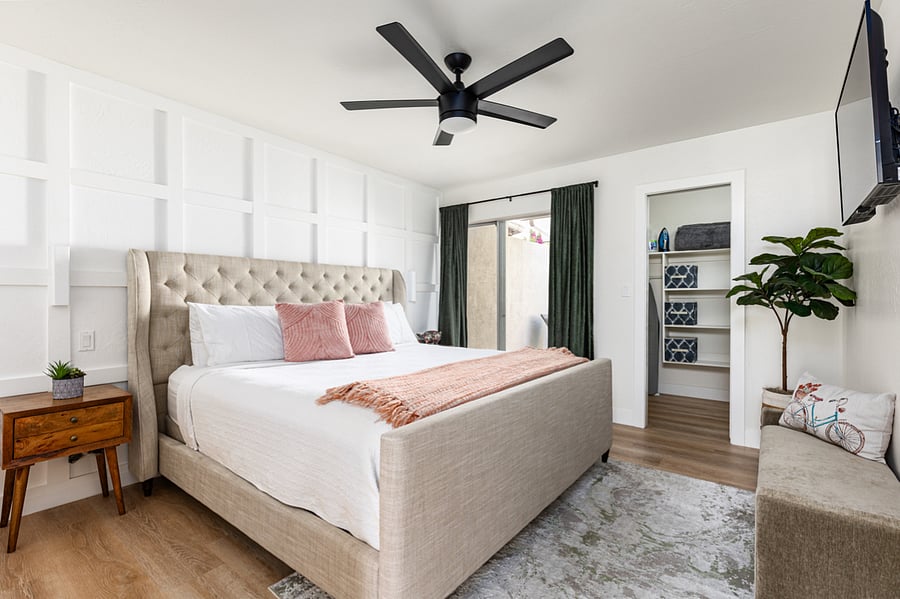 Master Bedroom with Sliding door out to private Patio. Big walk-in closet. Smart TV mounted on the wall.