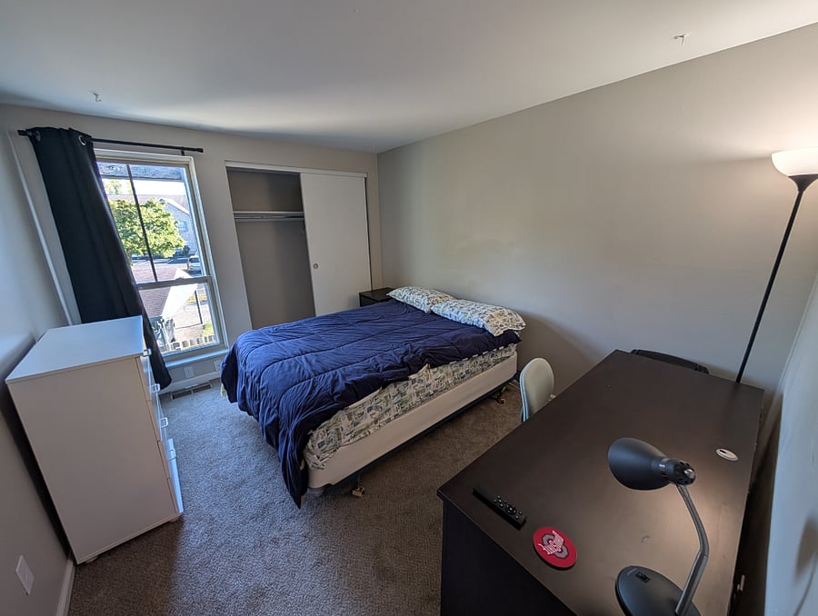 Bedroom 2 with double sized mattress, dresser, nightstand, and desk.