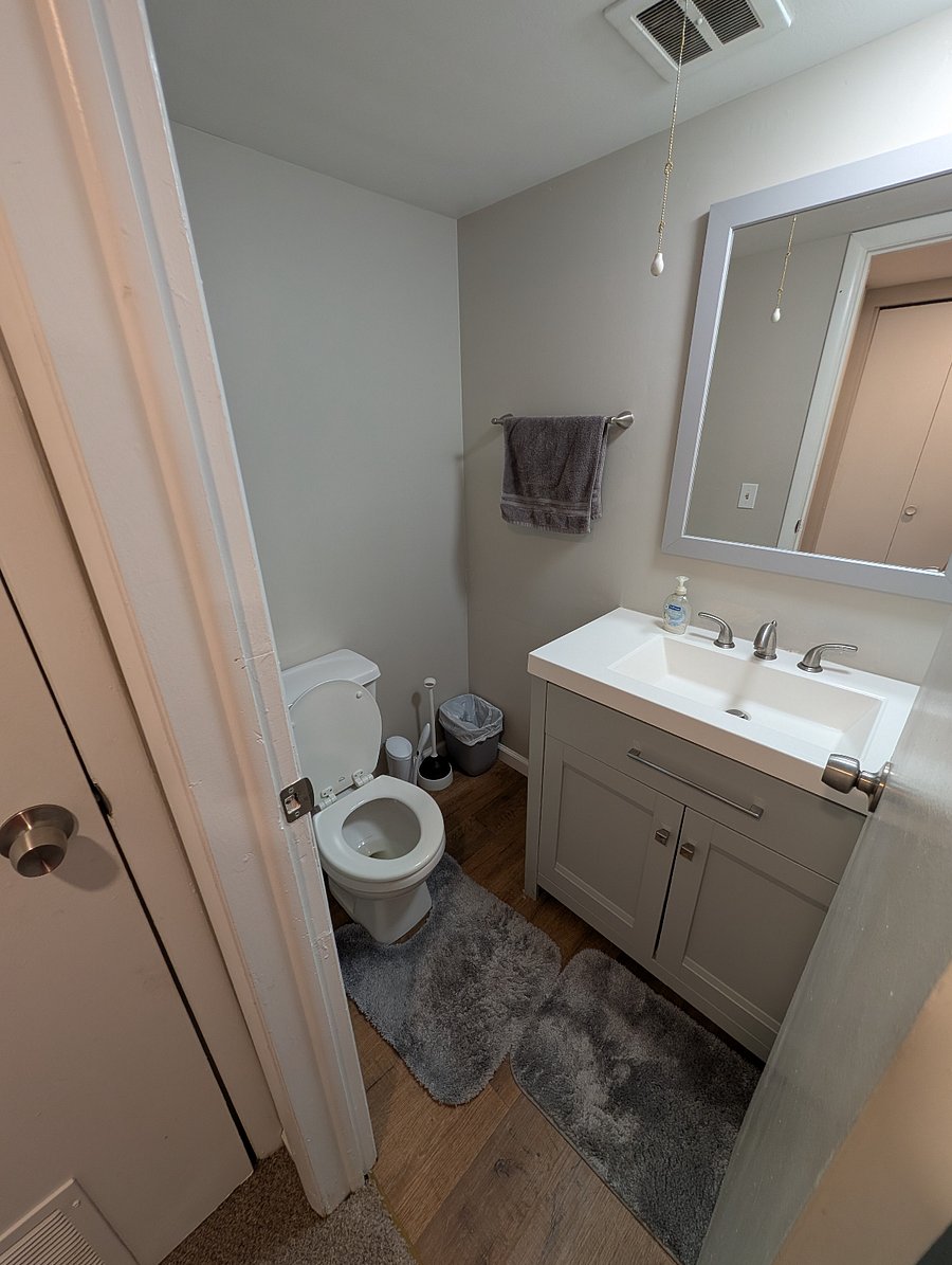 First floor half bathroom near laundry area.