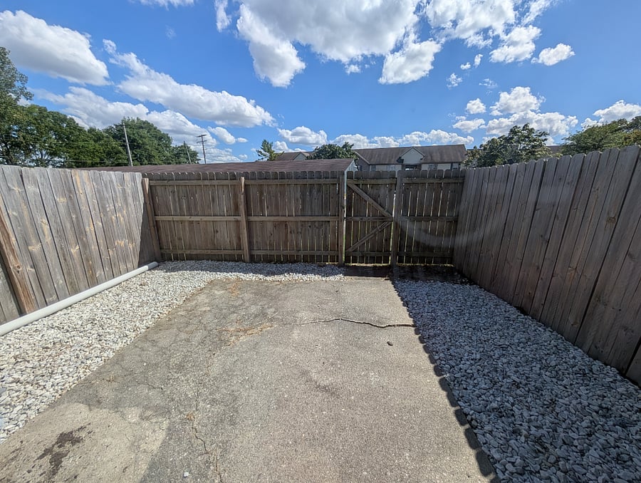 Patio area connected to the first floor living room via a sliding glass door.