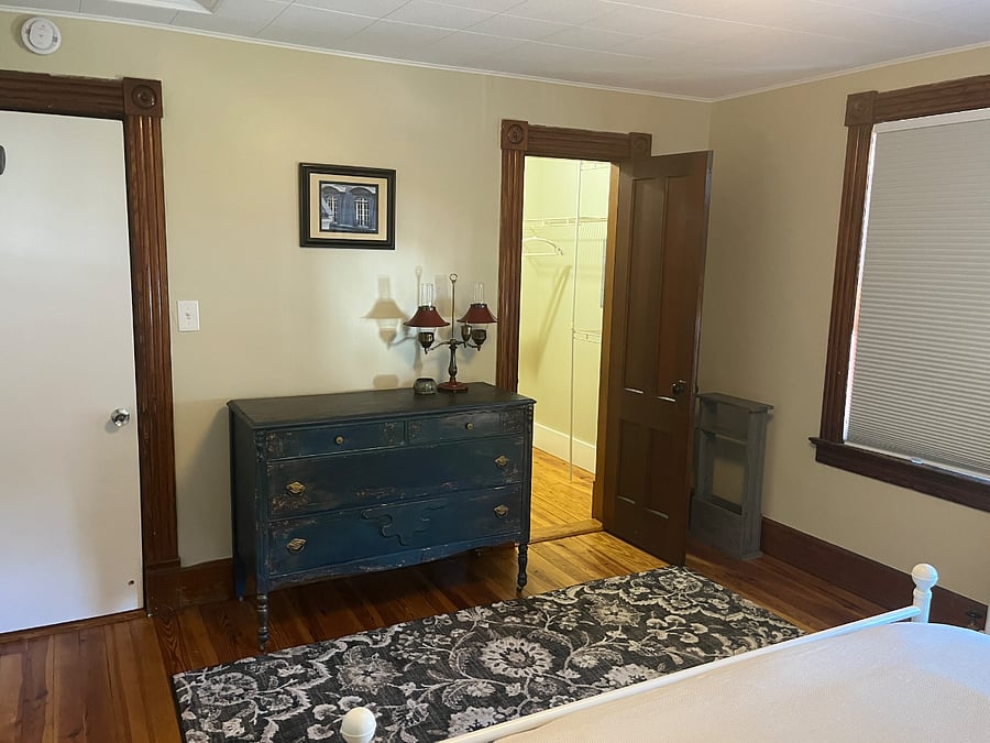 Bedroom 1 with Dresser and Walk In Closet Door Open