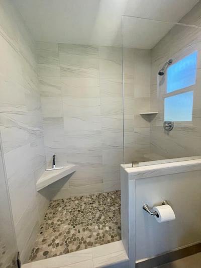 Marble shower with pebble stone base