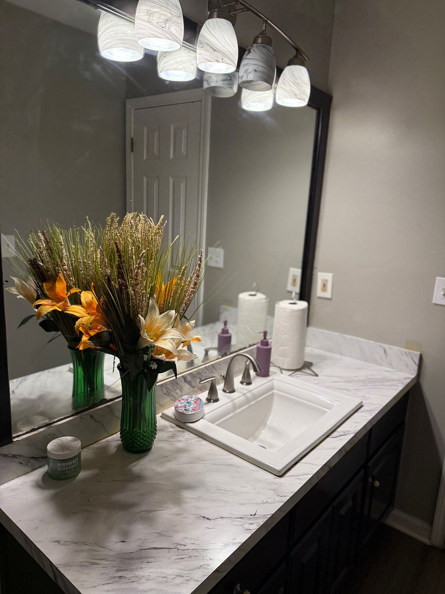 This photo features the shared bathroom, stocked with cleaning supplies.