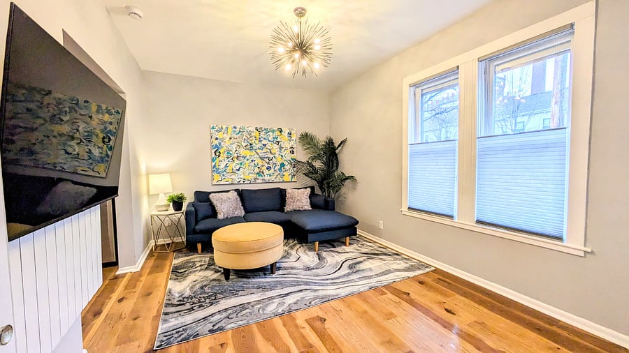 Upper unit living room is bright and open with view of the Schmidt Brewery