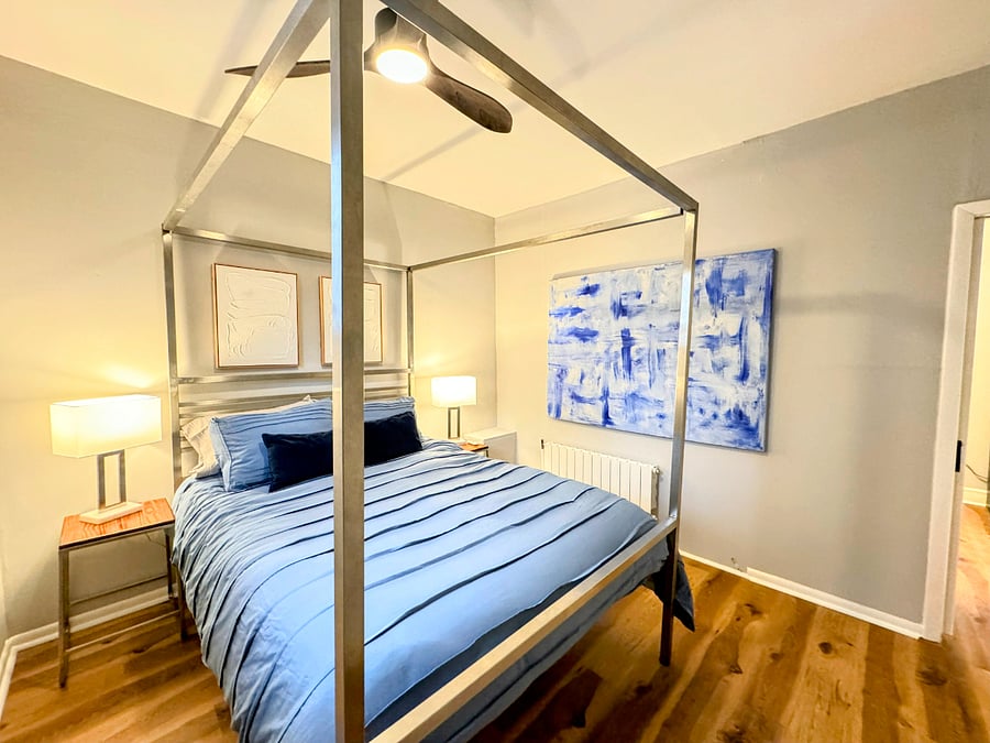 The upper unit had a stainless steel canopy bed frame, queen Casper mattress, and original artwork