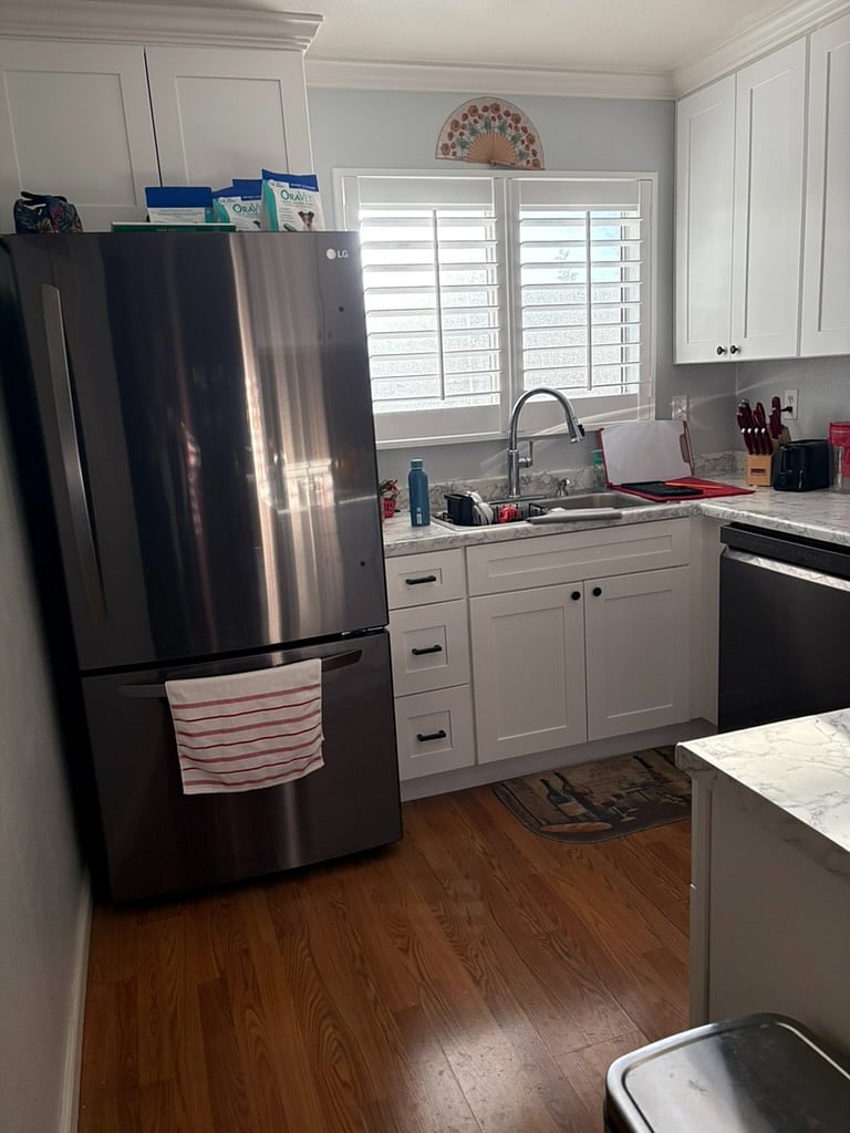 View into the kitchen with the shutters to the front patio shown. 