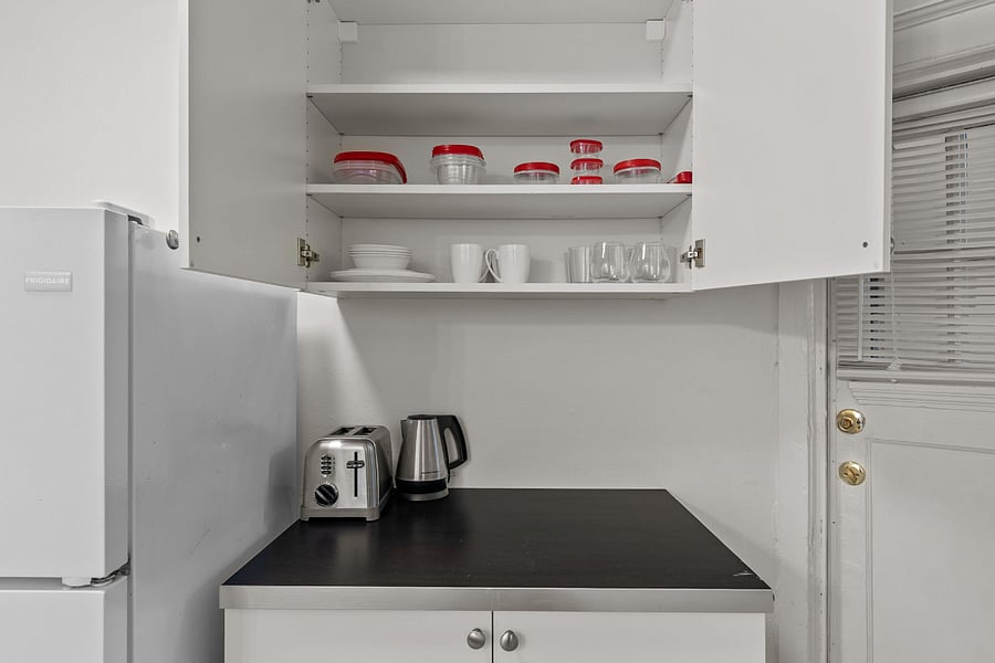 Well stocked kitchen with plates and glasses