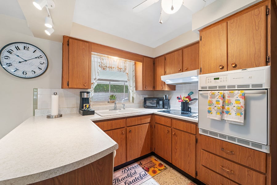 Full Kitchen with microwave, dishwasher, stove, and bar seating!