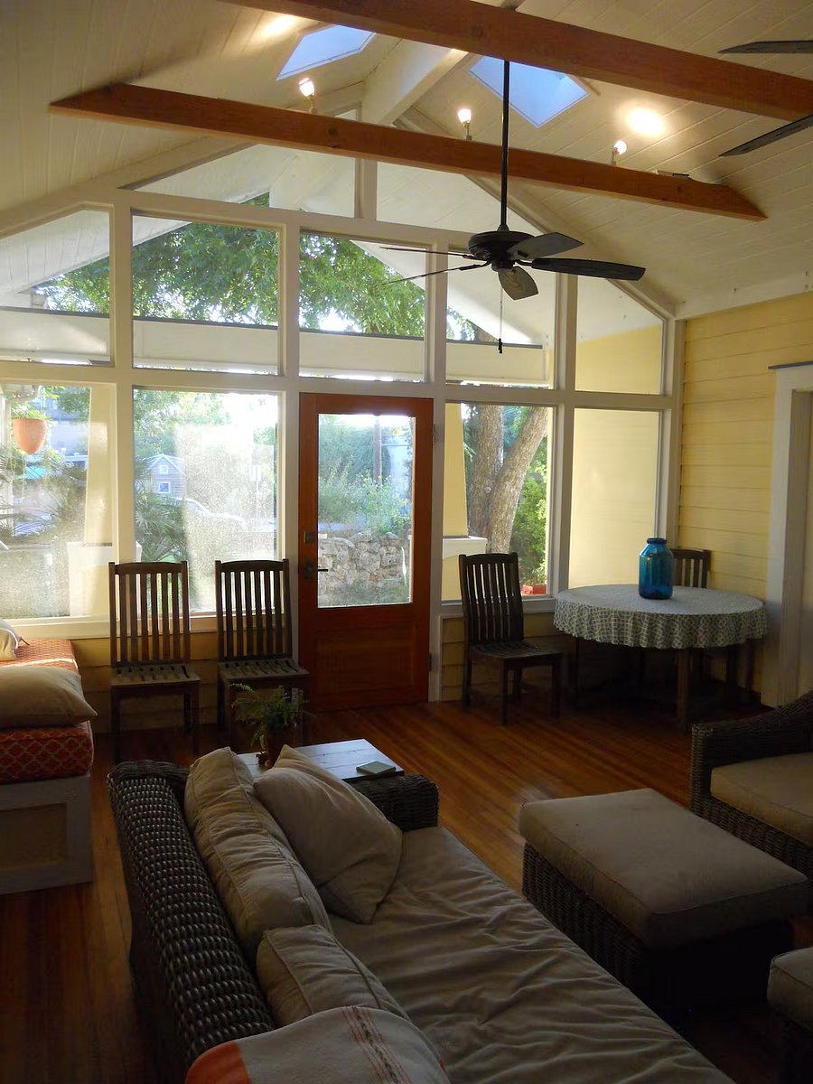 Screened porch with dining table.