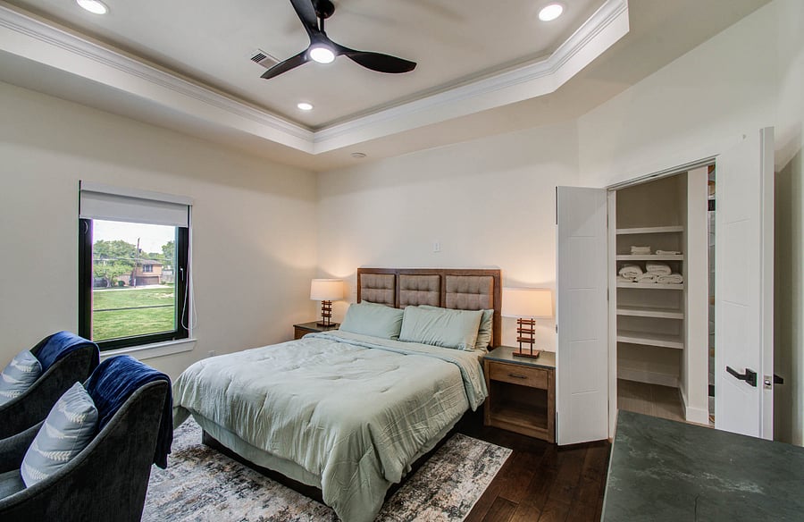 Primary bedroom has a king bed, seating area, work space and a smart TV