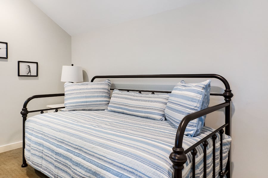 Loft with twin day bed and night stand.