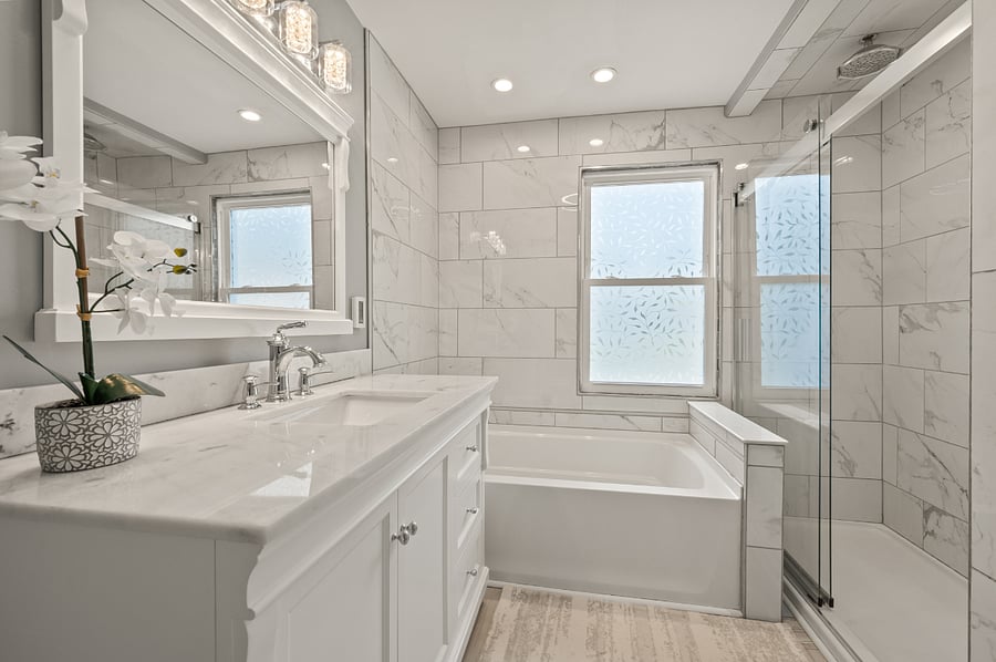main bath with soaking tub and dual shower. heated floors