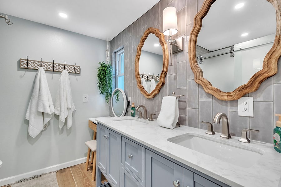 Master bathroom includes double sink vanity with marble top and ample storage underneath, a separate make-up vanity with lighted mirror and bench, partitioned commode area and full sized shower with sliding glass door. Shower has great water pressure. 
