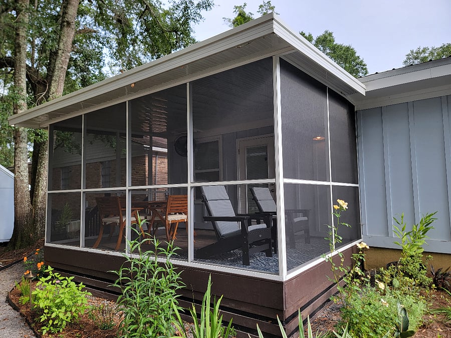 Screened in porch includes 4 seat dining table and 2 adirondack chairs for relaxing