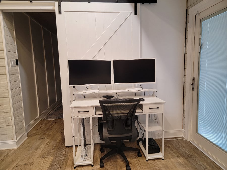 Desk with dual monitors and keyboard/mouse. Doubles as vanity with mirror.