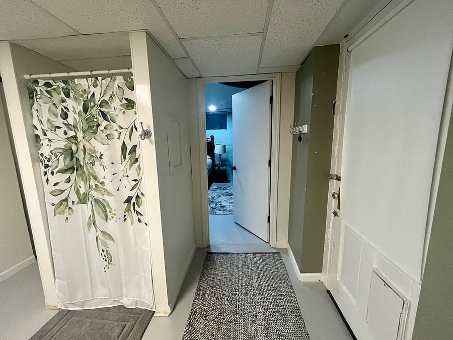 The door on the right is your private entrance. It goes out into a small stairwell that goes up into the backyard. The open door connects directly to the bedroom.