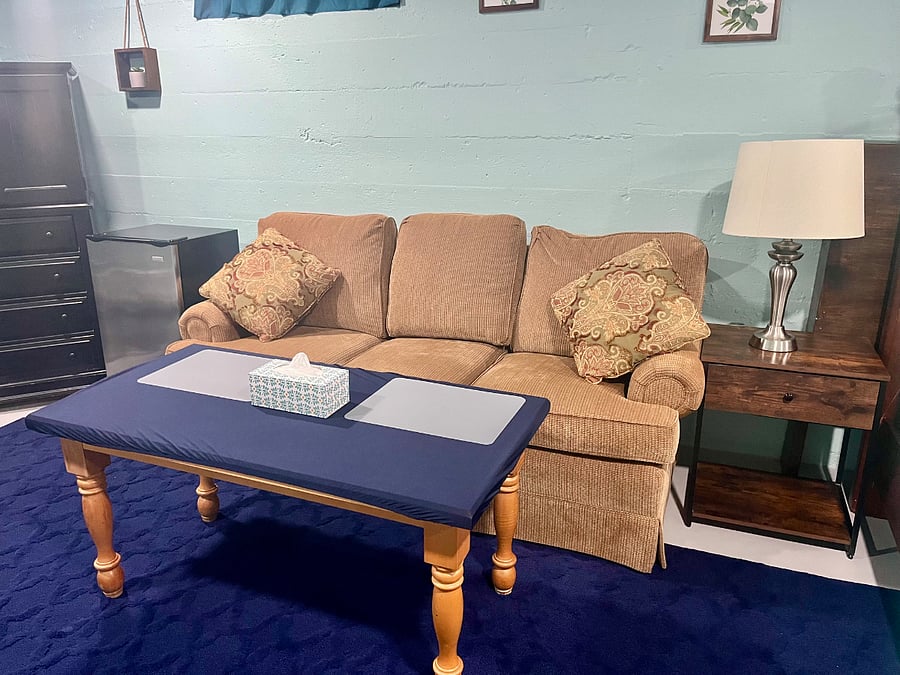Comfy couch with high coffee table where you can relax or eat a meal!