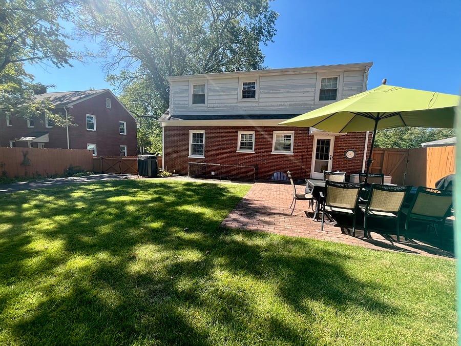The shared backyard is equipped with patio furniture to enjoy coffee or a meal outside.