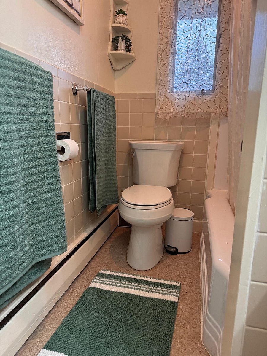 Full shower, vanity, and storage.