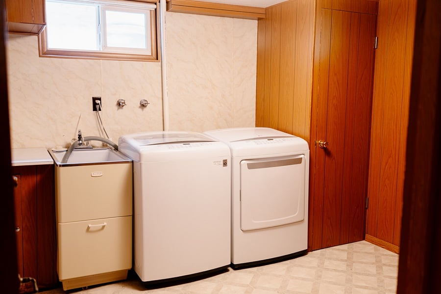 Full size laundry room with washer and dryer.