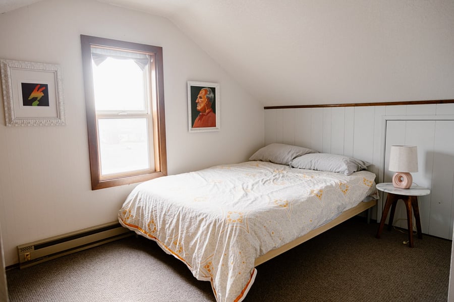 The smaller guest bedroom on 2nd floor is outfitted with a full size bed and window AC unit.