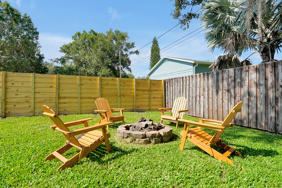 Relax by the fire pit in the fully fenced back yard.
