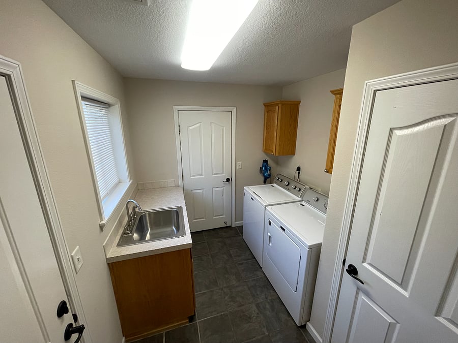 Laundry room with washer and dryer, utility sink and closet pantry