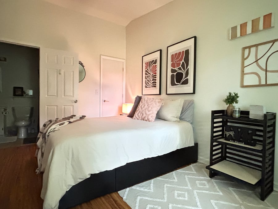 Queen bed with three storage drawers underneath and in-room wardrobe. Box fan available.