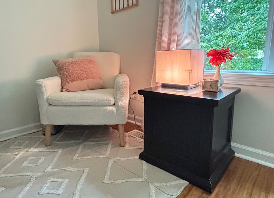 Cozy reading nook, overlooking serene backyard.