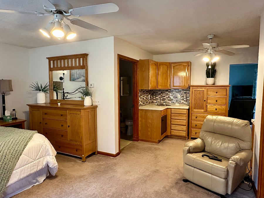 Dresser and bureau along with upper and lower cabinets for lots of storage.
Additional recliner in a spacious bedroom.