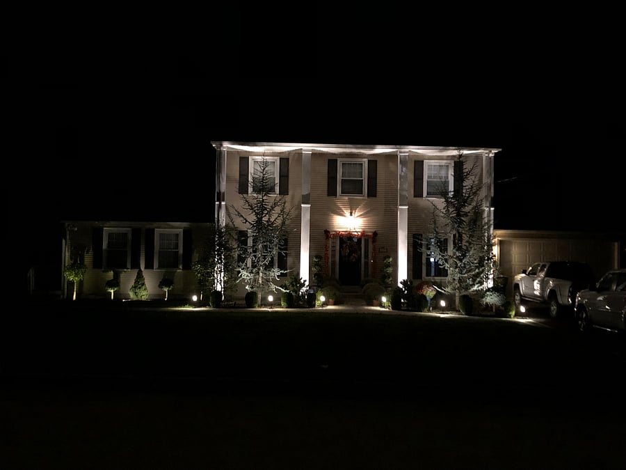 Well-lit property with motion lights leading to and down private side-entrance.