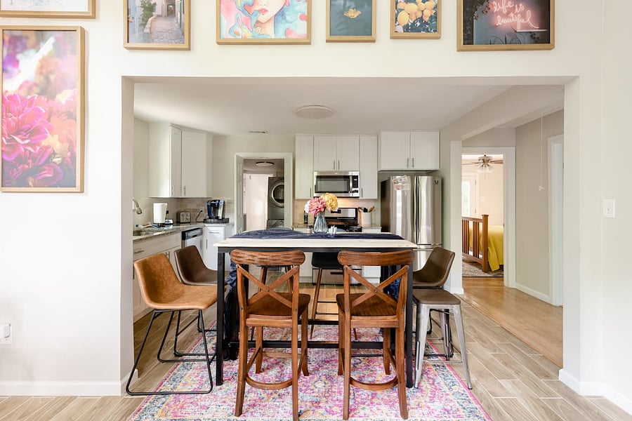 Dining room table has been updated with a regular height table and four dining room chairs.
