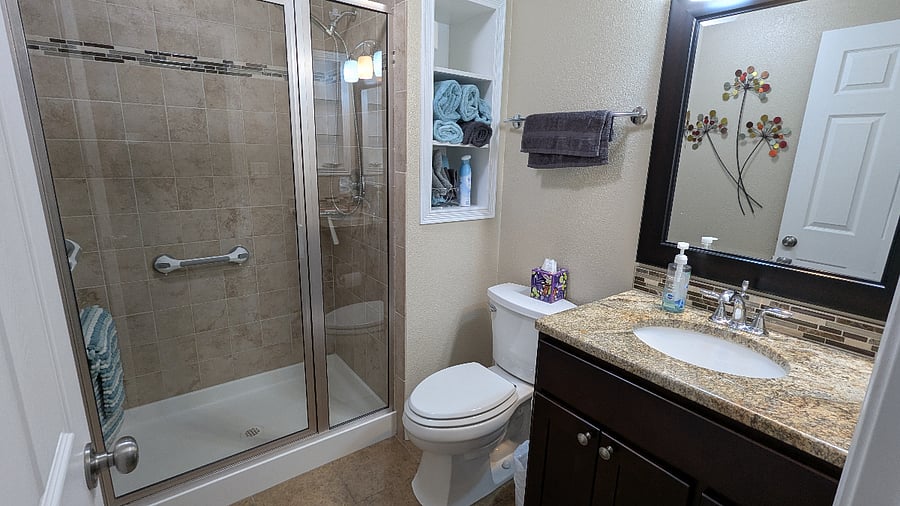 plenty of counter space, storage and room to shower in this well appointed bathroom