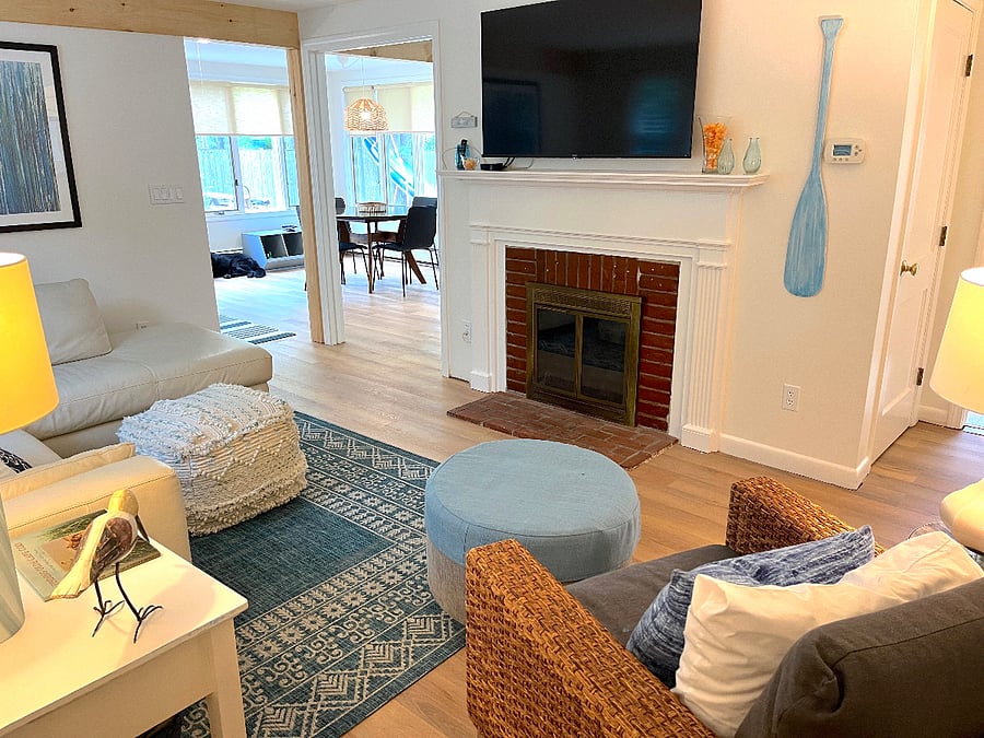 view of living room from front door, you see the sunroom on left and hallway to bedrooms on right