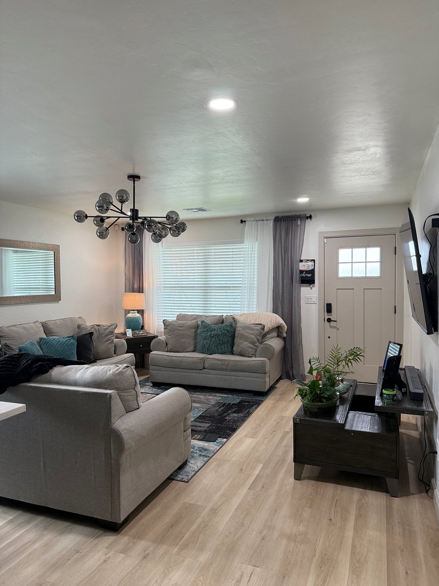 Cozy, comfortable, couch, loveseat, and oversized chair, 75inch Smart AI TV, lamp, end table, DVR.