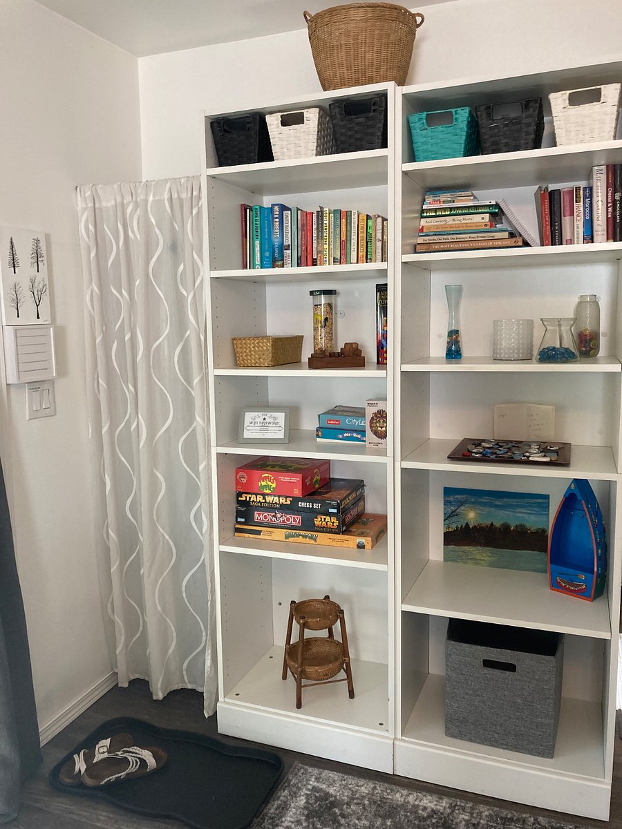 Book cases was even more storage. Behind that curtain is a place to hang your clothes.