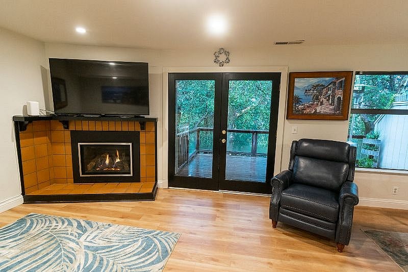 Cozy gas fireplace with beautiful forest views