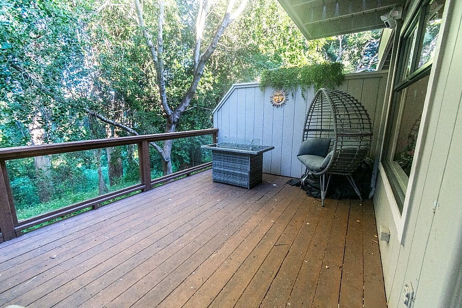 Outdoor furnished deck off of living room/dining room with additional outdoor fireplace and heat lamp