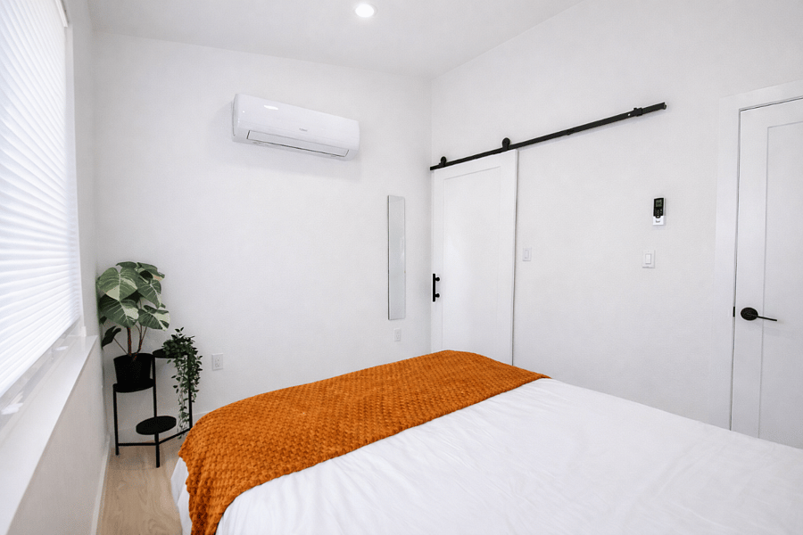 Bedroom with mini split heating and AC and closet storage