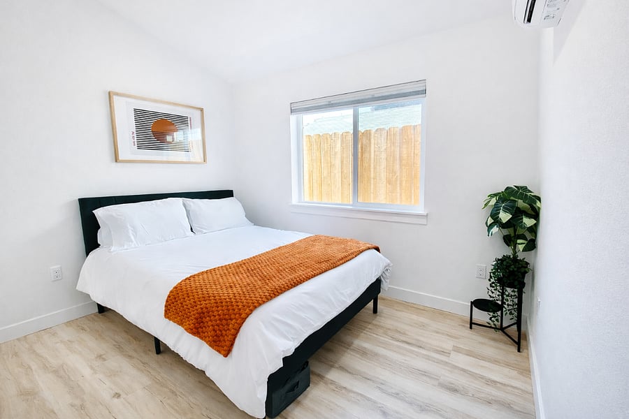 Queen bedroom with comfortable mattress and blackout shades