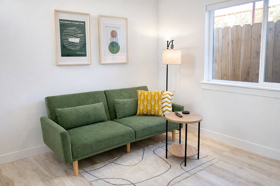 Living area with couch and open kitchen layout