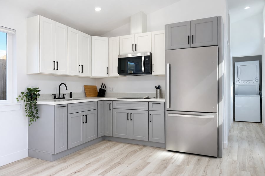 Full kitchen with refrigerator, microwave, cooktop, and storage