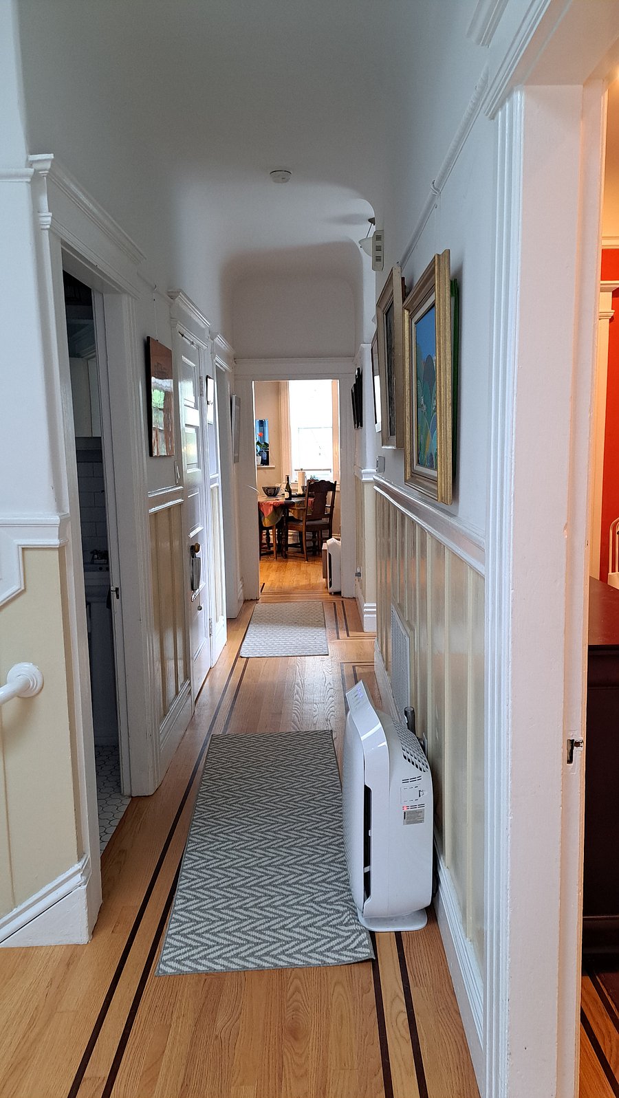 Hallway view taken from the landing toward the kitchen. The bathrooms are the first and third doors on the left. massage chair is out of view but would be on the left.