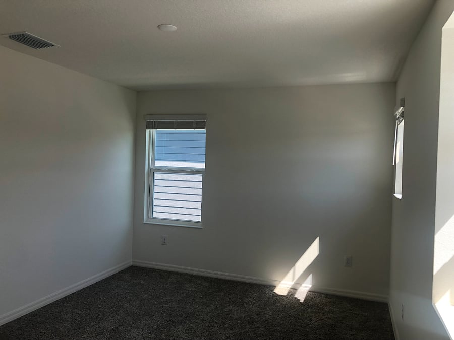 The upstairs bedroom is about 14' x 11'. It has a remote-controlled ceiling fan/light.